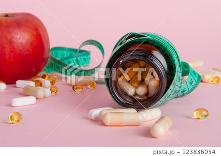 Weight Loss Pills and Measuring Tape, Diet Supplements Capsules, Obesity Lose Tablets, Color Drugs Pile 123836054