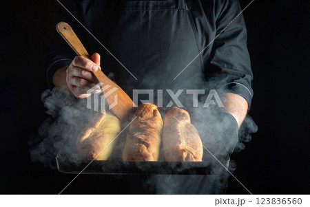 Baker preparing delicious pies. Tray with hot pies in hands of chef. Low key concept of cooking dinner or breakfast. Baker preparing delicious pies. Tray with hot pies in hands of chef. Low key concept of cooking dinner or breakfast. 123836560