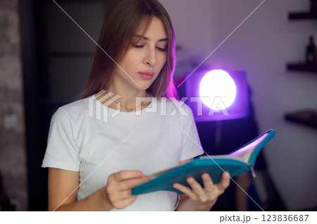 Bible, woman 20s study and writing, notes on religion at desk in home, Christian faith and knowledge of God. Reading, hope and girl holy book, learning gospel inspiration prayer in a white T-shirt Bible, woman 20s study and writing, notes on religion at desk in home, Christian faith and knowledge of God. Reading, hope and girl holy book, learning gospel inspiration prayer in a white T-shirt 123836687