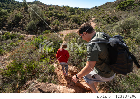 Caucasian family hiking adventure in scenic nature trail with lush greenery Caucasian family hiking adventure in scenic nature trail with lush greenery 123837206