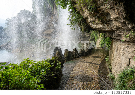 Walkway under the waterfall at Furongzhen in Hunan, China. 123837335