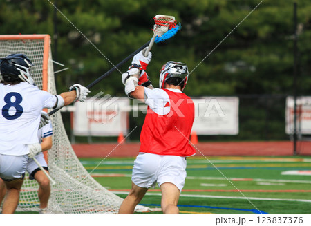 Lacrosse Player Taking a Shot On goal During a Competitive Game Lacrosse Player Taking a Shot On goal During a Competitive Game 123837376