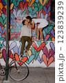 A couple poses by a colorful heart mural in the city, happily enjoying each other 123839239