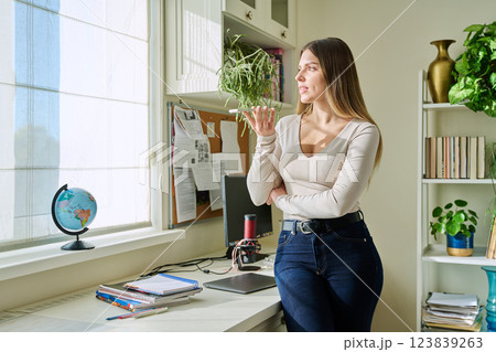 Young woman recording audio message on smartphone, at home 123839263