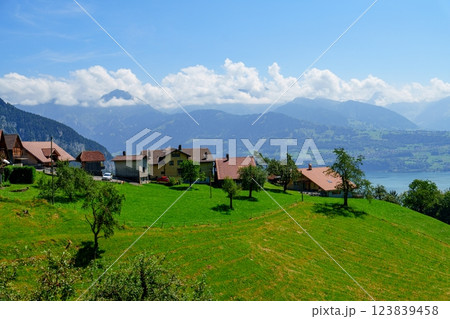 Breathtaking View of Picturesque Swiss Village Nestled Among Majestic Mountains and Tranquil Lake Breathtaking View of Picturesque Swiss Village Nestled Among Majestic Mountains and Tranquil Lake 123839458