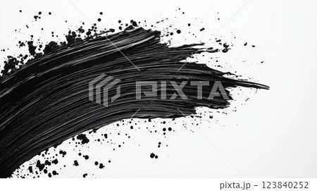 Black acrylic paint stroke with splatters on white background 123840252