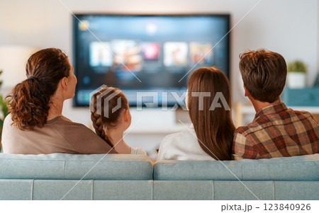 family watching  TV in the evening at home 123840926