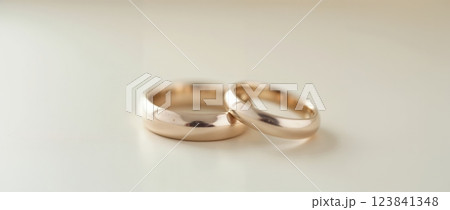 Two gold wedding bands on white background Two gold wedding bands on white background 123841348