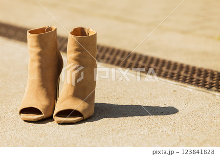 Brown boots with high heels and peep toes Brown boots with high heels and peep toes 123841828