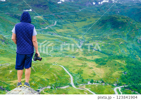 Tourist with camera and in Norway mountains Tourist with camera and in Norway mountains 123841904