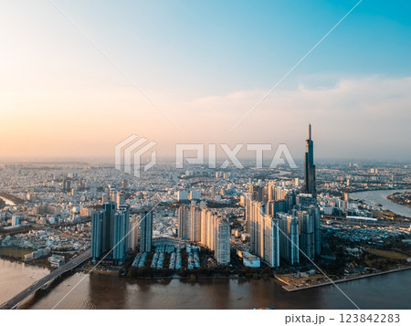 beautiful sunset over Ho Chi Minh city skyline and Saigon river, green tropical park and financial downtown district with tall skyscraper towers, Vietnam aerial drone view beautiful sunset over Ho Chi Minh city skyline and Saigon river, green tropical park and financial downtown district with tall skyscraper towers, Vietnam aerial drone view 123842283