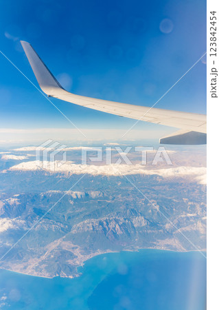 View from the airplane window of the mountains and sea resort with corals in Egypt, Sharm El Sheikh.Flight 123842454