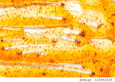 Close up of fresh honey and bee pollen drizzled on honeycomb surface with golden 123842819