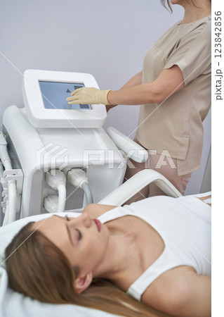 Young caucasian female receiving cryotherapy treatment while attended Young caucasian female receiving cryotherapy treatment while attended 123842856