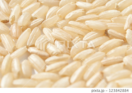 Close up of uncooked white rice grains showing texture and details in natural 123842884