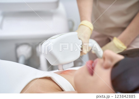 Asian female receiving laser hair removal treatment at beauty clinic Asian female receiving laser hair removal treatment at beauty clinic 123842885
