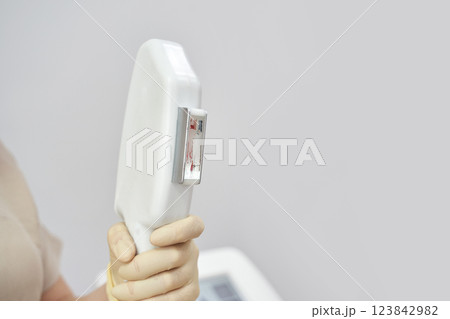 Caucasian female adult holding medical machine component for diagnostic 123842982