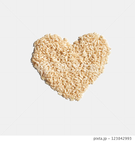 Heart shape made of uncooked rice grains on white background Heart shape made of uncooked rice grains on white background 123842993