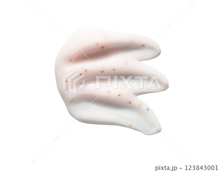 Smudge of white cream with exfoliating parts and light texture on white 123843001
