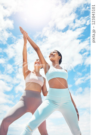 Pilates, personal trainer and woman client learning wellness, support and workout exercise accountability or trust on blue sky clouds. Stretching people, mentor or coach training with sun lens flare 123843101