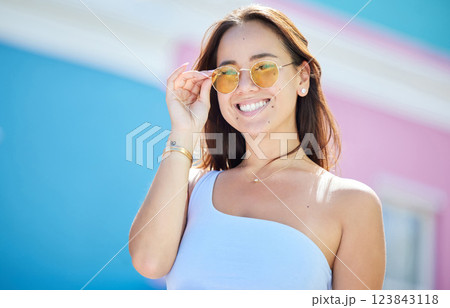 Summer, fashion and sunglasses, style and woman while happy in urban and cityscape. Young, Asian model and stylish accessories, gen z travel and vacation, trendy and fashionable in the street. 123843118