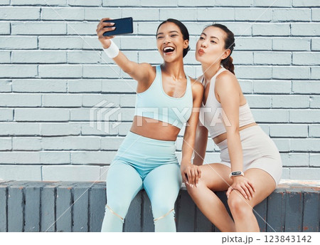 Fitness friends, phone selfie and picture for social media, influencer content and happy workout after exercise and training by brick wall. Fit females take wellness, fun and online motivation photo 123843142