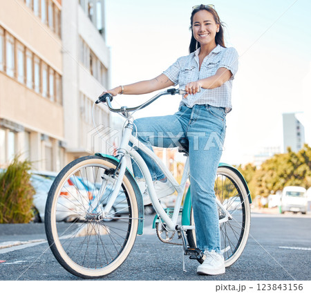 Woman, bicycle and smile for travel in the city, streets of a student relaxing in the outdoors. Portrait of a happy asian female traveling on cycling tour in a urban town on a bike in South Africa Woman, bicycle and smile for travel in the city, streets of a student relaxing in the outdoors. Portrait of a happy asian female traveling on cycling tour in a urban town on a bike in South Africa 123843156