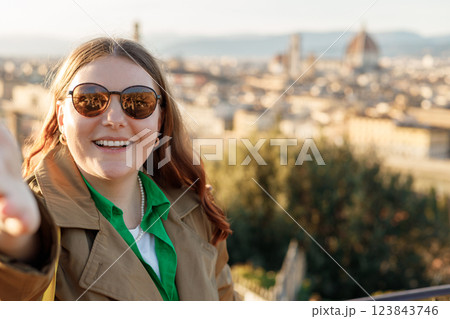 Young female tourist resting in Italy. Florence city landscape panoramic view. Stylish woman visiting Italian landmarks. Traveling Europe, Italy in spring, holidays concept. 123843746
