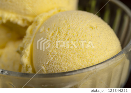 creamy ice cream with yellow banana slices in a glass cup creamy ice cream with yellow banana slices in a glass cup 123844231