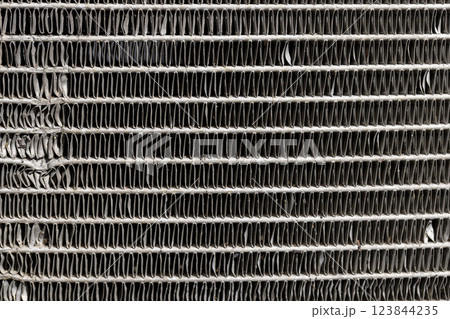 an old car radiator made of lead damaged after an accident an old car radiator made of lead damaged after an accident 123844235