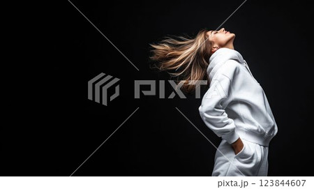 Fashionable Woman in White Sweatshirt Posing Against Black Background 123844607