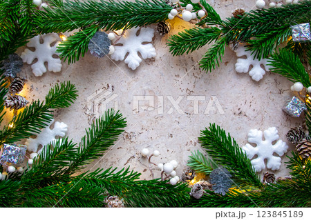 Christmas tree spruce for frame with light, gifts, snowflake and decor on the wood background in winter day. Copy space. Top view. Christmas tree spruce for frame with light, gifts, snowflake and decor on the wood background in winter day. Copy space. Top view. 123845189