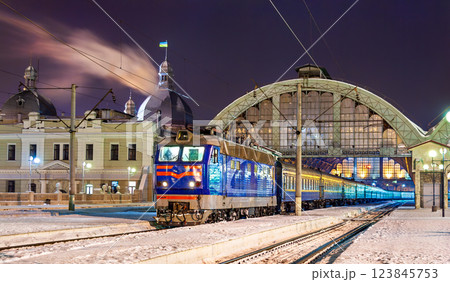 Typical Ukrainian passenger train at Lviv station with Ukraine flag on a winter night 123845753