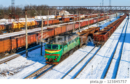 Diesel locomotive with a heavy freight train in winter in Korosten, Zhytomyr Oblast of Ukraine 123845757