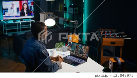 Smiling employee saluting managers, using online videocall to ask for feedback on project progress. Cheerful worker waving hand, greeting coworkers in teleconference meeting, camera B 123848973