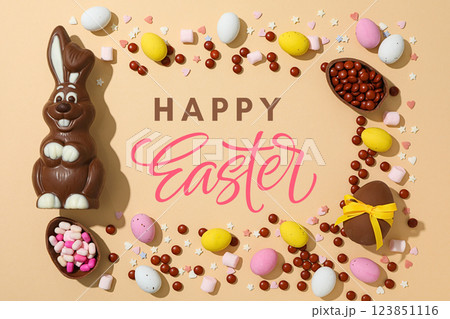 Easter, greeting inscription with chocolate eggs, candies and a bunny, on a pink background Easter, greeting inscription with chocolate eggs, candies and a bunny, on a pink background 123851116