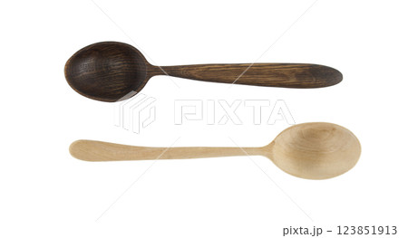 Two handcrafted wooden spoons, one dark and one light displayed against a white background. 123851913