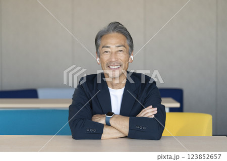 カメラ目線で話すイヤホンをした笑顔の60代の男性 123852657