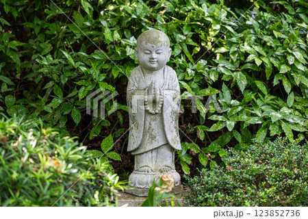 A Serene Statue in a Chinese Garden 123852736