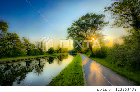 The Serene River Pathway at Sunrise offers a stunning and peaceful view, ideal for exploration The Serene River Pathway at Sunrise offers a stunning and peaceful view, ideal for exploration 123853438