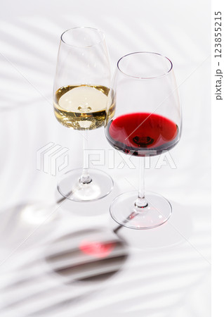 Two wine glasses filled with red and white wine Two wine glasses filled with red and white wine 123855215
