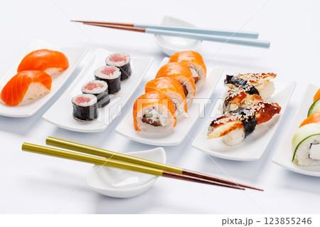 Assorted sushi and maki rolls beautifully arranged on plates Assorted sushi and maki rolls beautifully arranged on plates 123855246