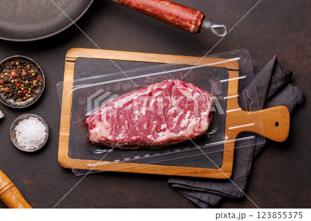 Raw marbled striploin steak, fresh, rich, ready for cooking Raw marbled striploin steak, fresh, rich, ready for cooking 123855375