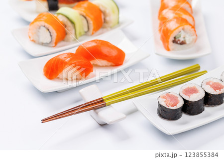 Assorted sushi and maki rolls beautifully arranged on plates 123855384