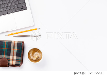 A clean and minimal desk setup featuring a laptop and a coffee cup A clean and minimal desk setup featuring a laptop and a coffee cup 123855416