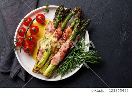 Grilled asparagus with bacon and egg sauce on a plate Grilled asparagus with bacon and egg sauce on a plate 123855433