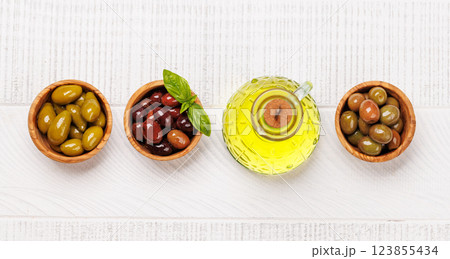 An assortment of various olives presented in a bowl, showcasing different colors, textures, and flavors An assortment of various olives presented in a bowl, showcasing different colors, textures, and flavors 123855434