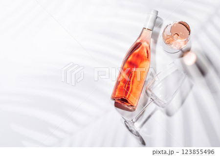 A bottle of rose wine paired with a glass 123855496