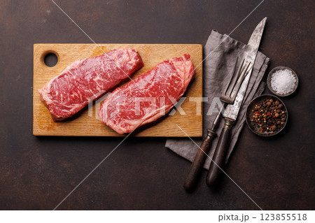 Raw marbled striploin steak, fresh, rich, ready for cooking Raw marbled striploin steak, fresh, rich, ready for cooking 123855518