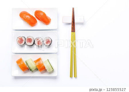 Assorted sushi and maki rolls beautifully arranged on plates Assorted sushi and maki rolls beautifully arranged on plates 123855527